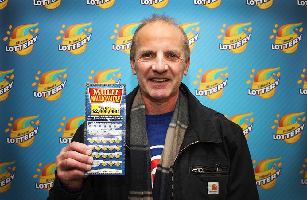 Zeraldas Usonis as he holds his winning Multi Millionaire ticket.