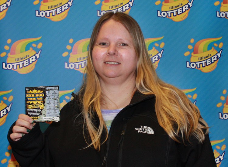 Alicia Bunch holds her winning $20,000 Taxes Paid ticket.​ 