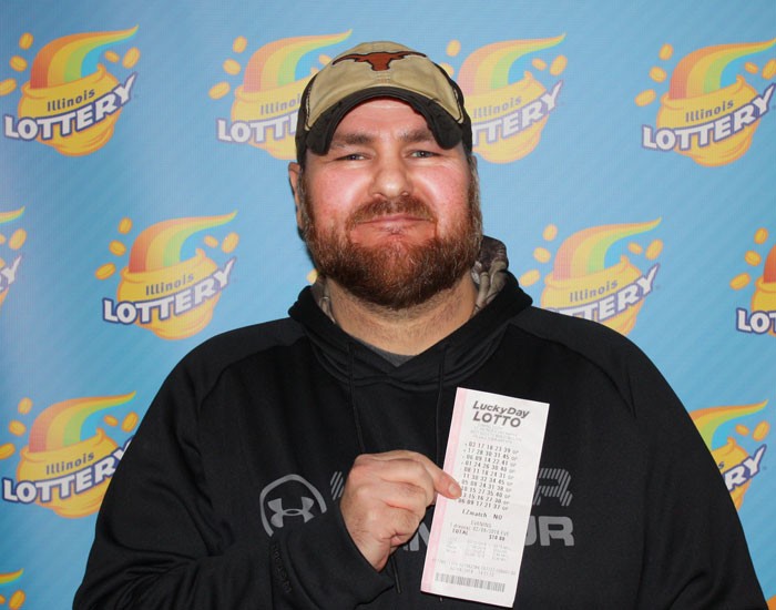 William Woolsey holds his winning $550,000 Lucky Day Lotto ticket.