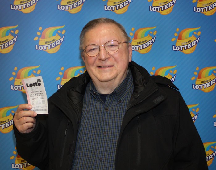 Charles Vincent holds his winning Lotto ticket.​