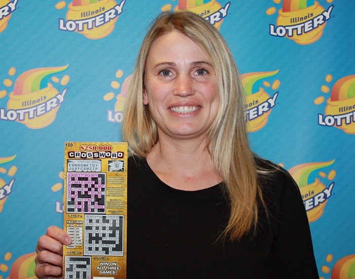 Angela Stottler holds her winning $250,000 Crossword instant ticket.
