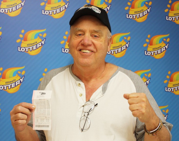 Joseph Loney holds his winning Mega Millions ticket.