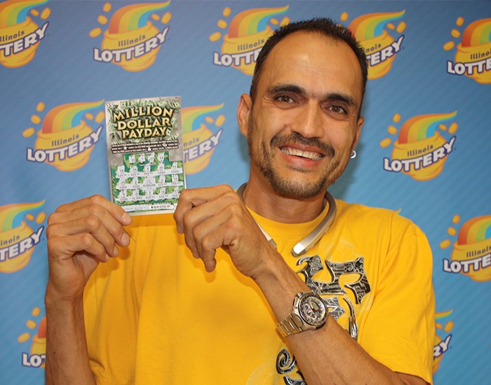 Luis Rivera holds his winning Million Dollar Payday ticket.