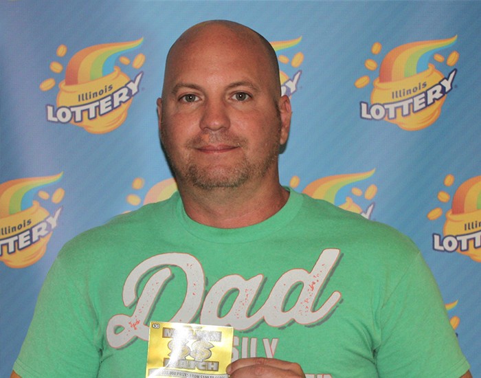 Brandon Bradbury holds his winning Million $$ Match ticket.